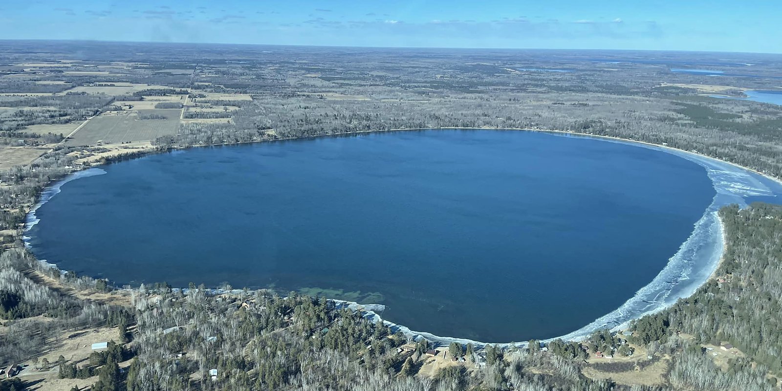 Aerial view of Grace Lake in early spring with ice still ringing the shoreline